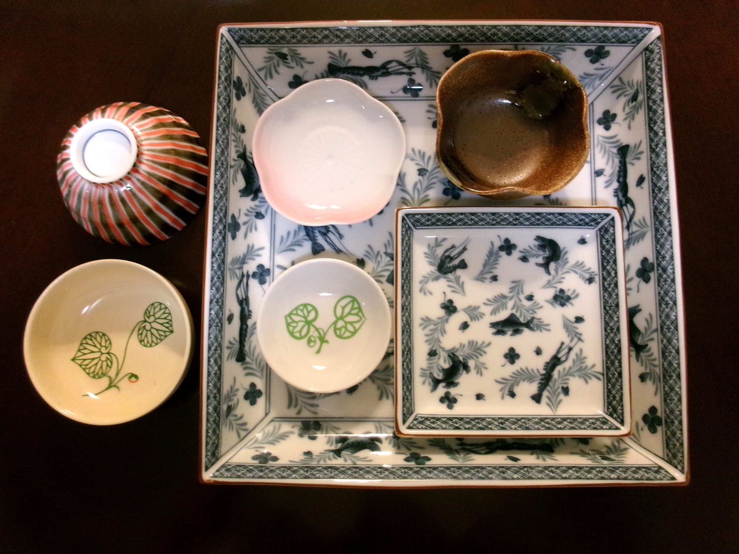 A variety of Japanese-style plates and small rice bowls