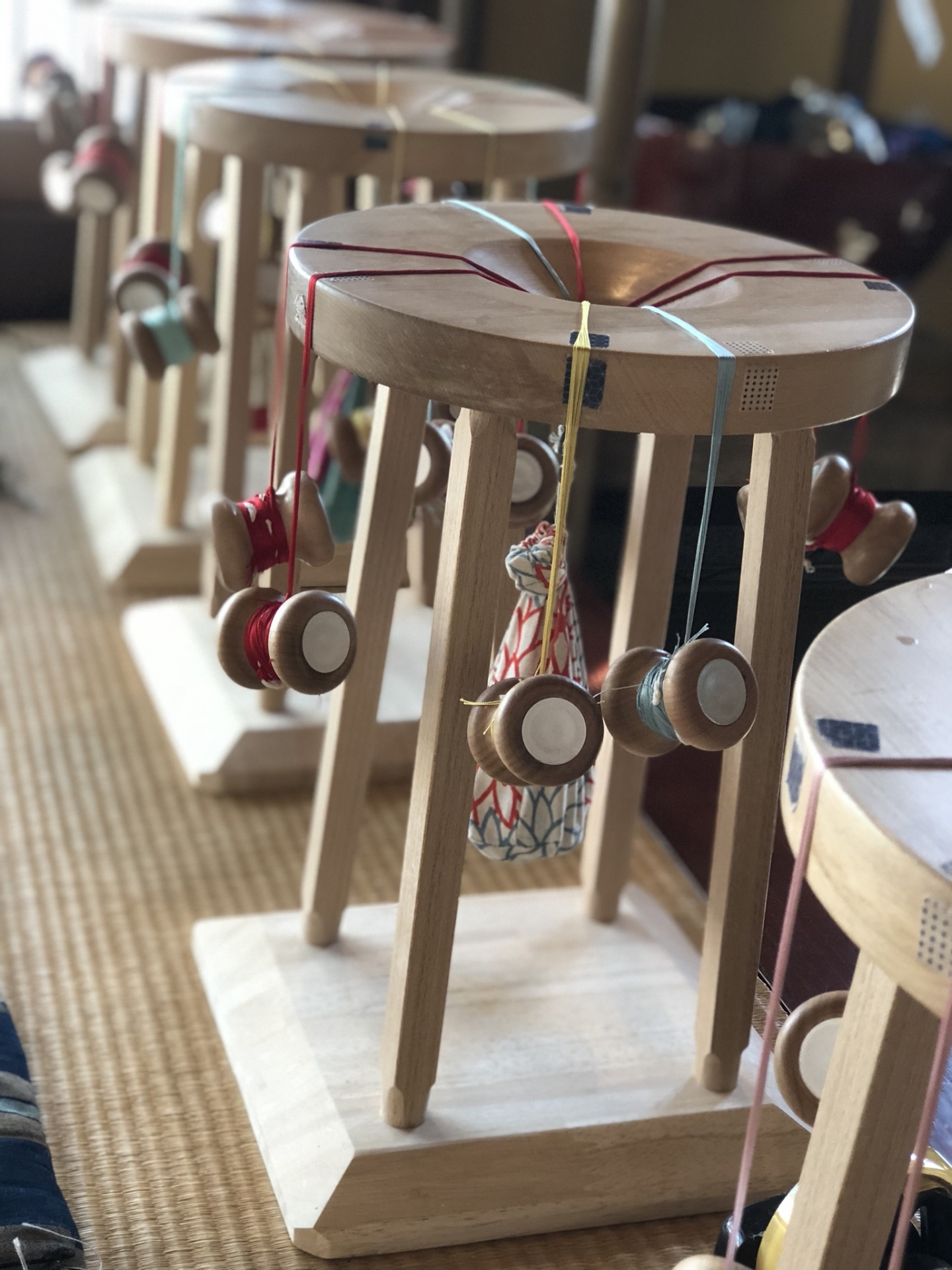 Traditional Japanese kumihimo braiding on wooden marudai stands